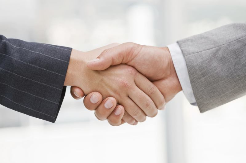 Business people joining hands together for deal