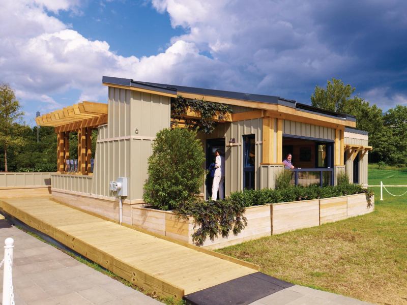 The students used a prototype sliding mechanical window system to transform the porch into a sun space in the winter months.