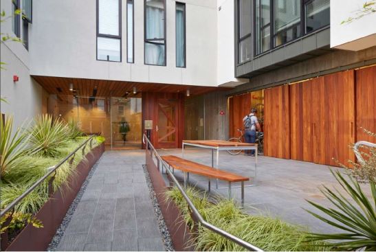 Barn doors conceal centrally located bicycle-storage rooms at David Baker Architects' 300 Ivy project in San Francisco.