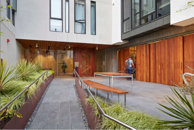 Barn doors conceal centrally located bicycle-storage rooms at David Baker Architects' 300 Ivy project in San Francisco.