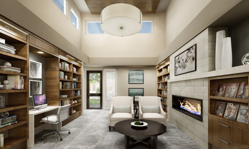 The building's inviting library features a computer station, a fireplace, and comfortable seating.