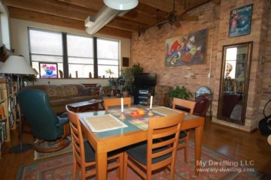 The Milwaukee condo features brick walls and hardwood floors.