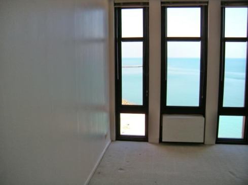 The Chicago condo features floor-to-ceiling windows with lake views.