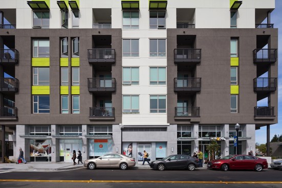 The French gray/green/white exterior color schemes lend a lively street rhythm to the development's surroundings.