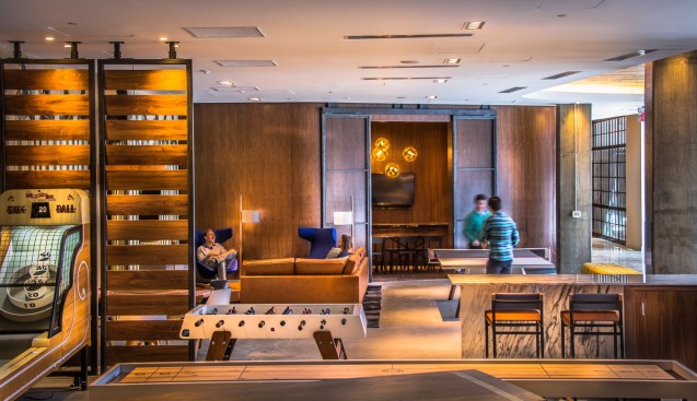 The generous yet cozy game room welcomes residents with a variety of offerings, from table tennis to Skee-Ball to foosball.&nbsp;