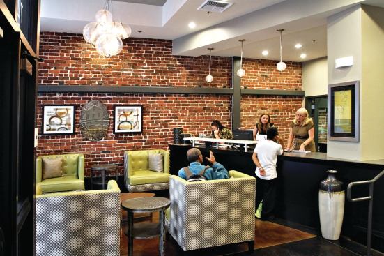 The new lobby, with comfortable seating and exposed brick wall.