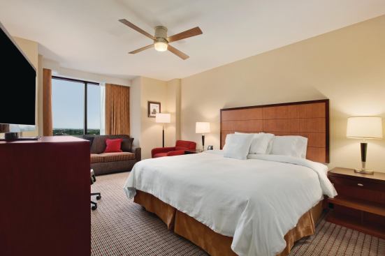 A bedroom in a suite at the Homewood Suites by Hilton in University City.